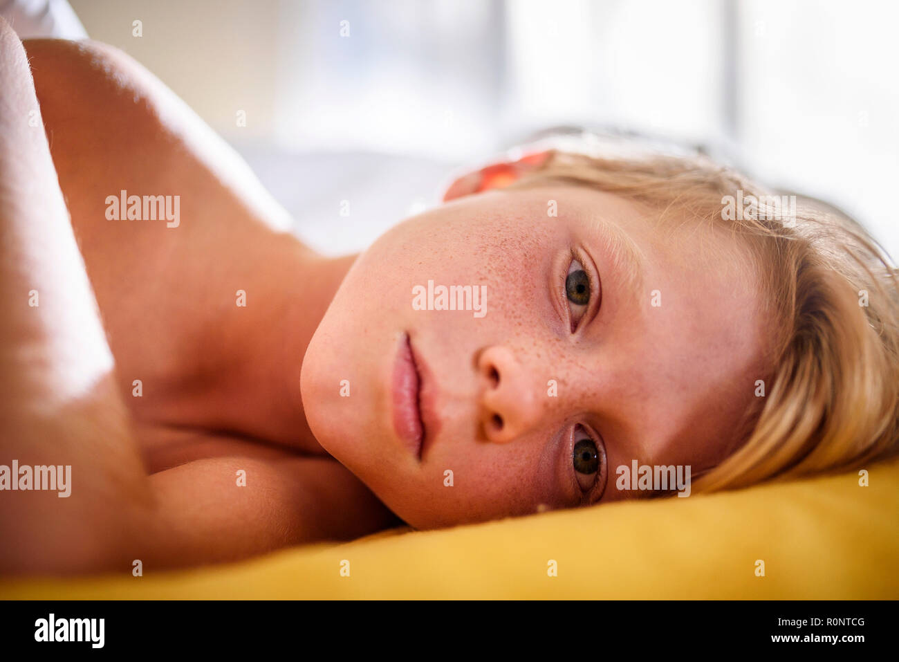 Portrait of a boy in bed waking up Stock Photo