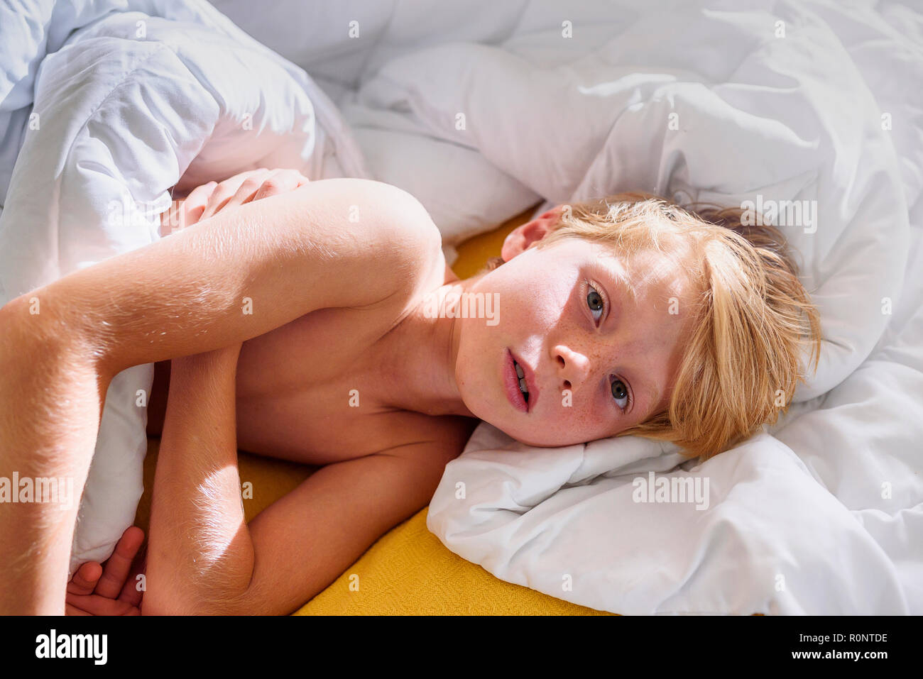 Overhead view of a boy lying in bed Stock Photo