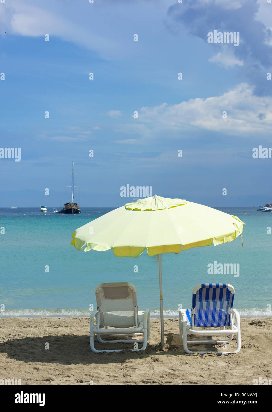 Two sun loungers under a beach umbrella, Valletta, Malta Stock Photo