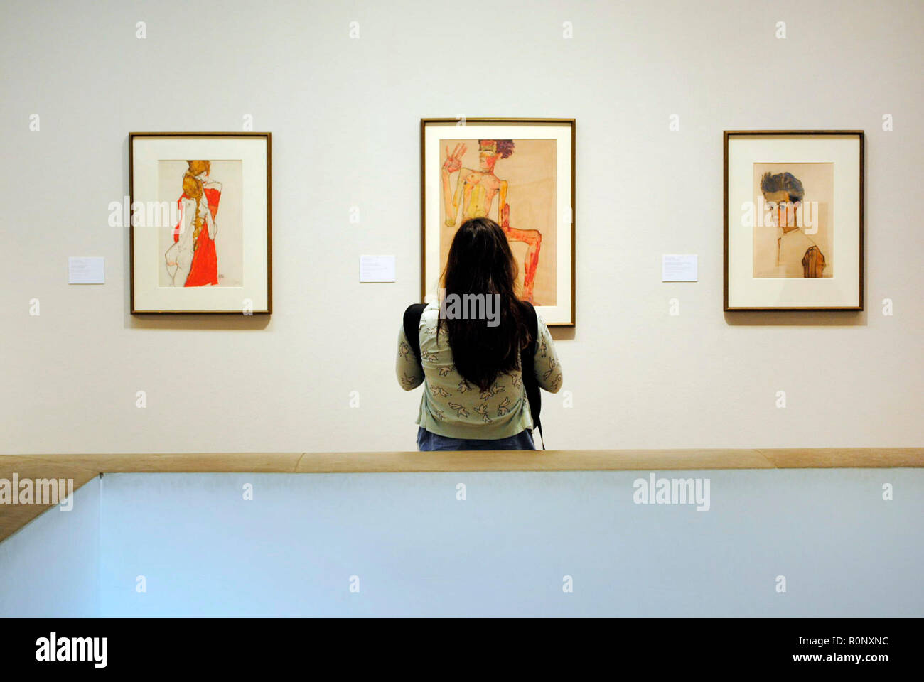 Austria. Vienna. Leopold Museum. Woman contemplating Egon Schiele painting in a museum room dedicated to this Austrian Expressionist painter. Egon Schiele (1890-1918). Stock Photo
