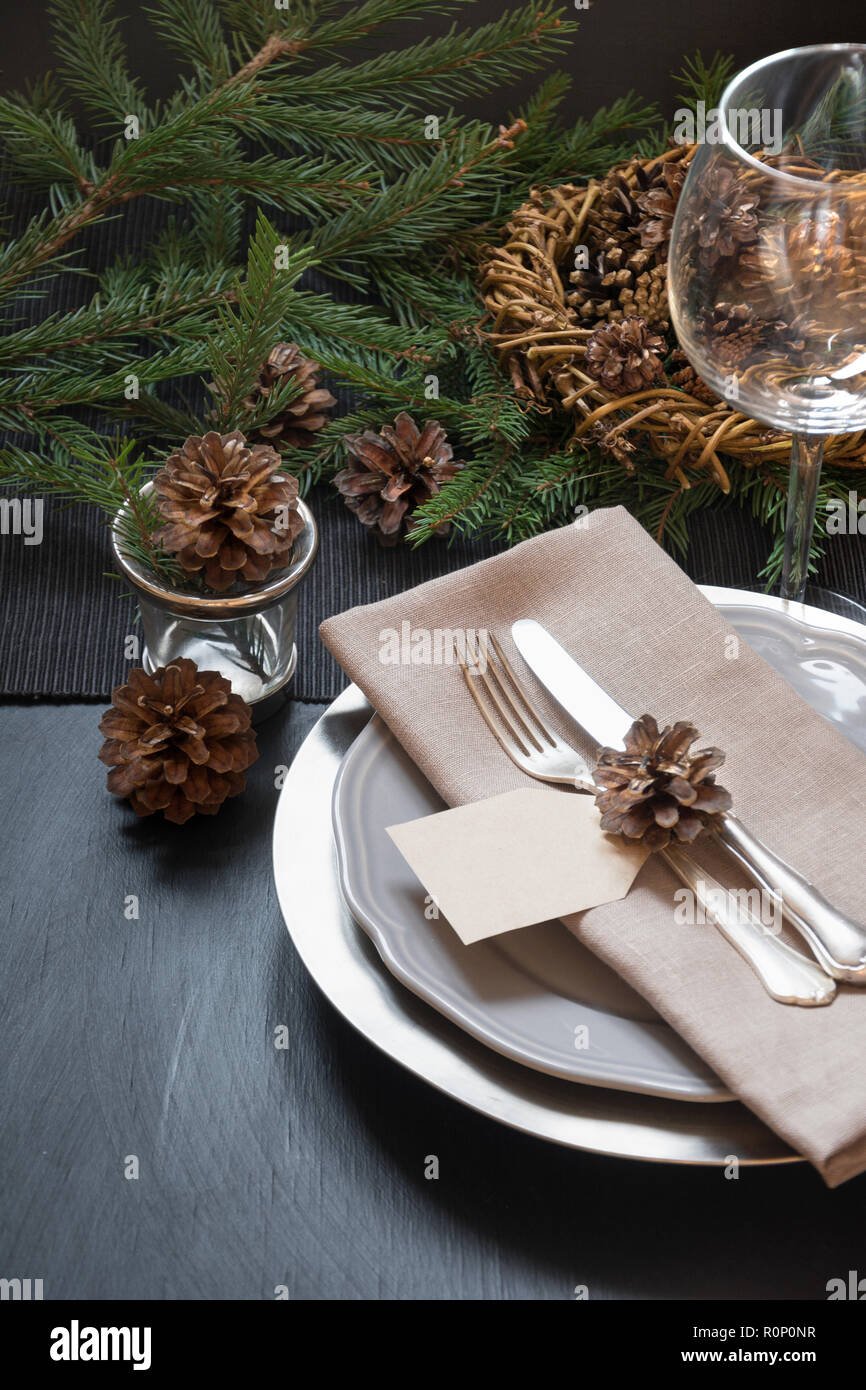Christmas Table Setting With Silverware And Dark Natural Evergreen Decor On Black Table Top View Holiday Centerpieces Stock Photo Alamy