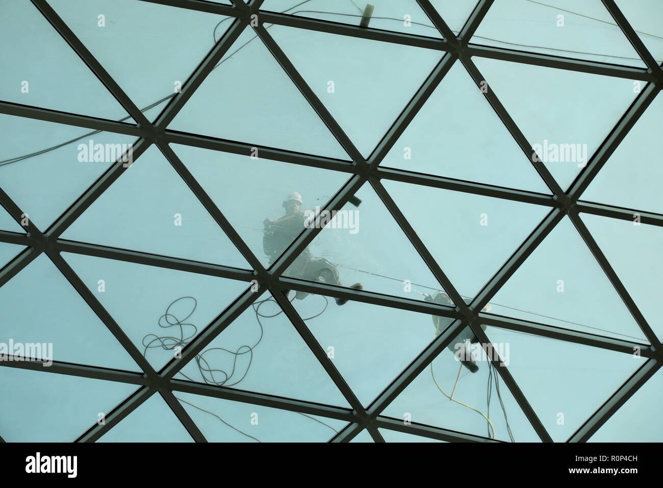 London, UK – October 5 2018: Workers clean the glass and steel roof above the Great Court of the British Museum Stock Photo