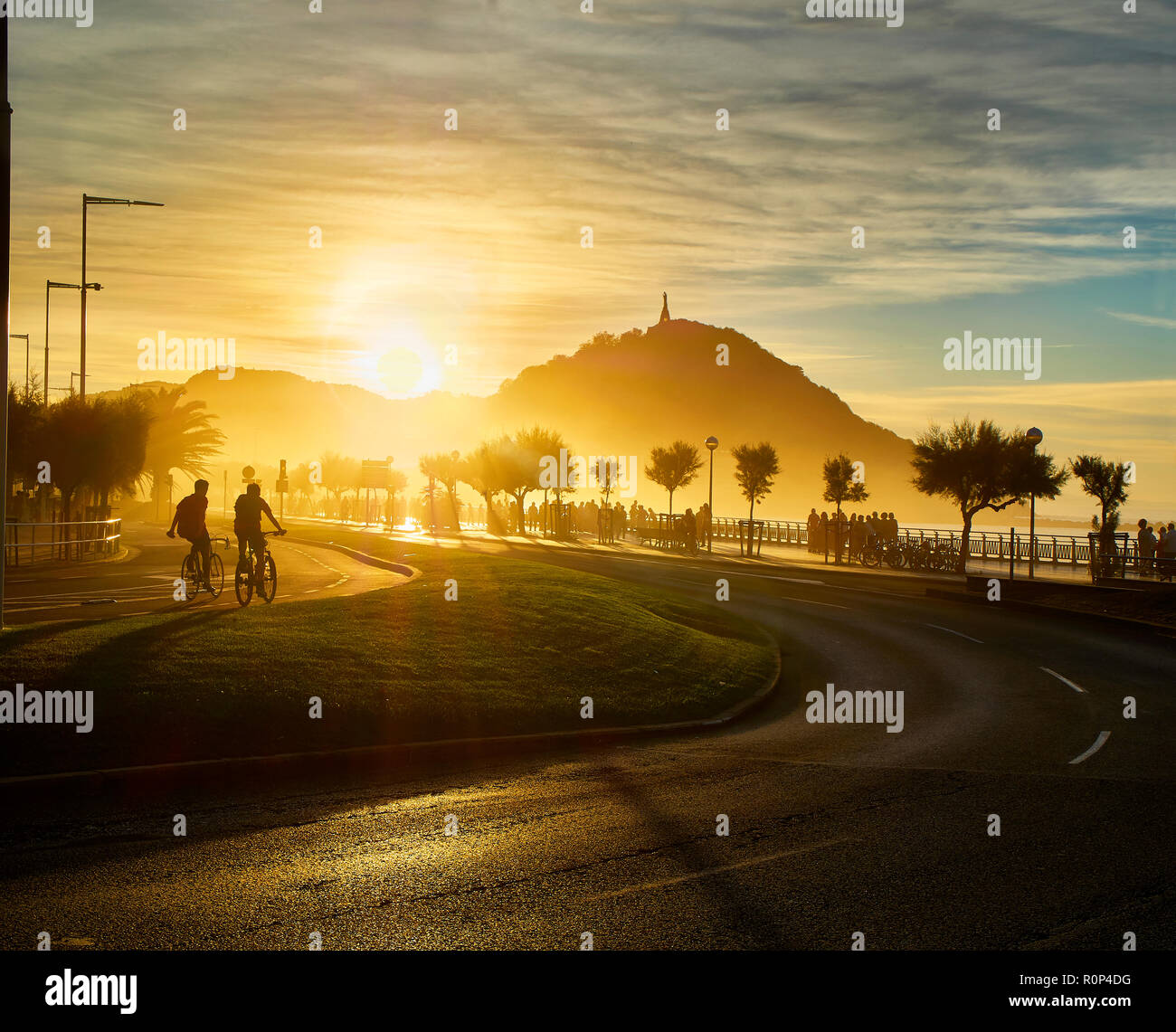 The sun sets behind the Monte Urgull of San Sebastian, Basque Country, Guipuzcoa. Spain. View from Zurriola Avenue. Stock Photo