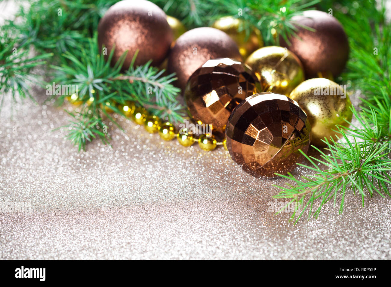 Christmas decorations and evergreen fir tree branch closeup on gold ...