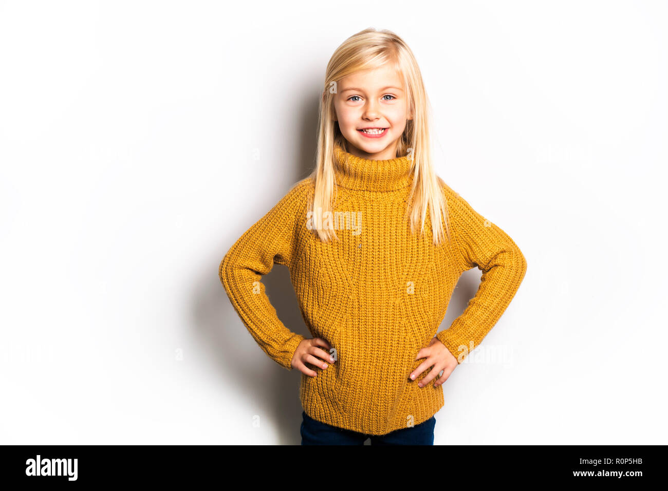 A Cute girl 5 year old posing in studio Stock Photo