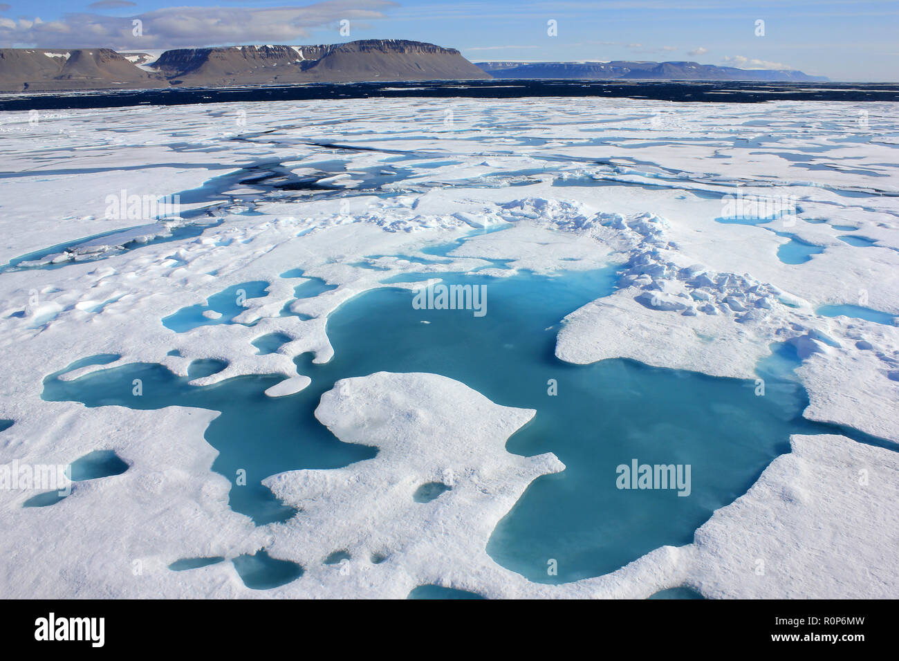 Frozen Landscape of Lancaster Sound With Devon Island in Background, Arctic Canada as seen from CCGS Amundsen Stock Photo
