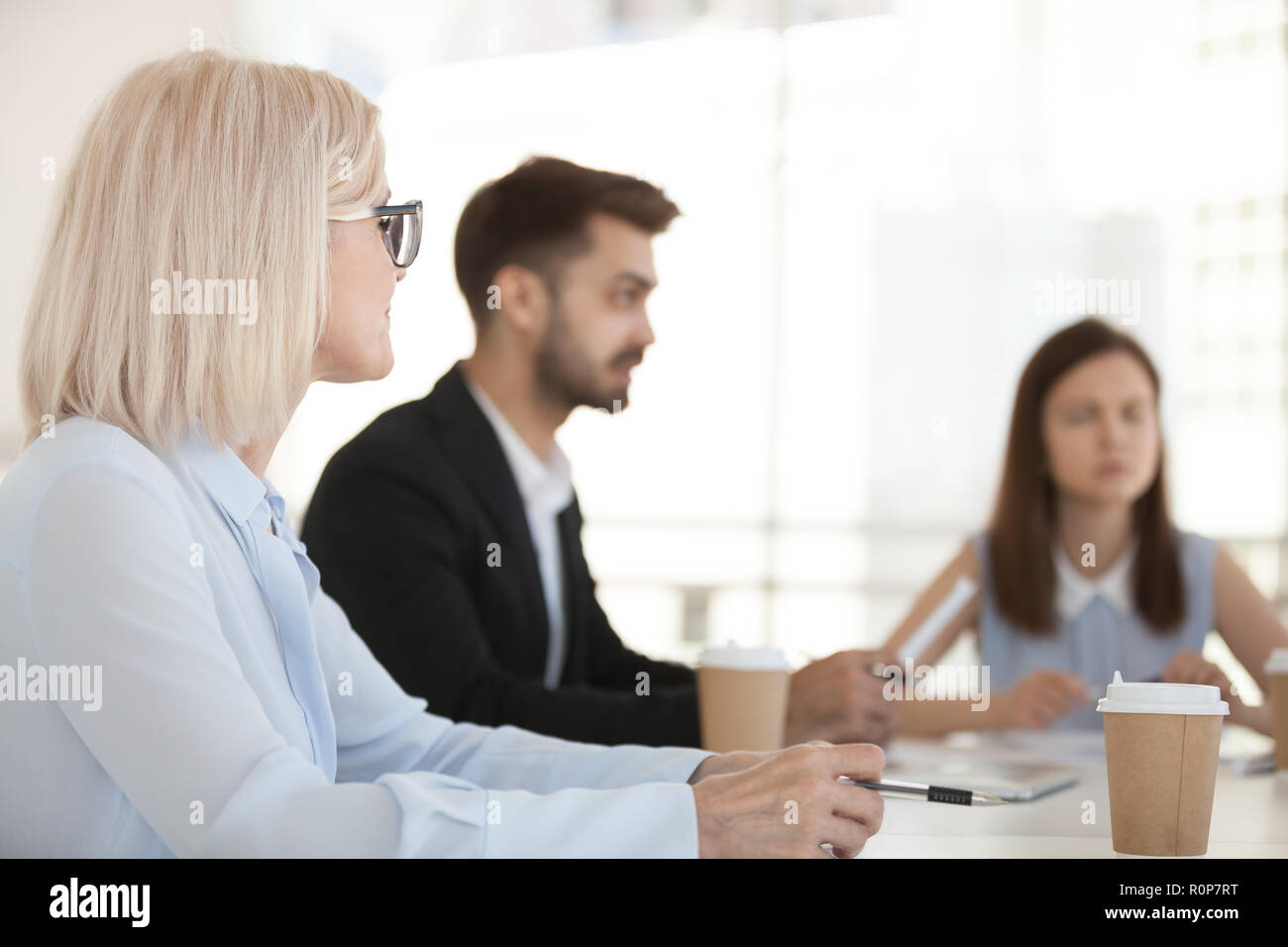 Diverse employees have negotiation at office meeting Stock Photo