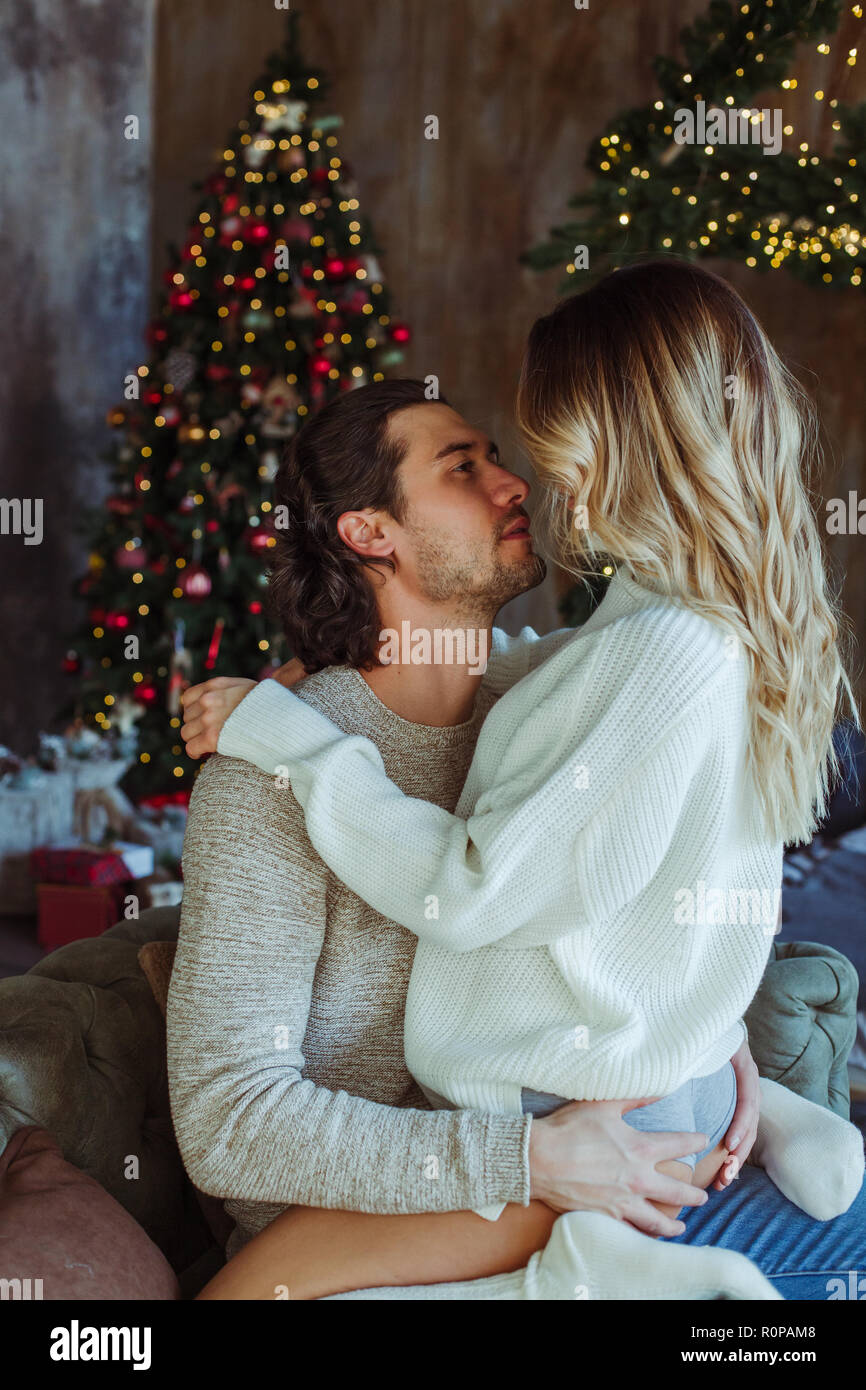 Young couple celebrating Christmas in a rural home Stock Photo