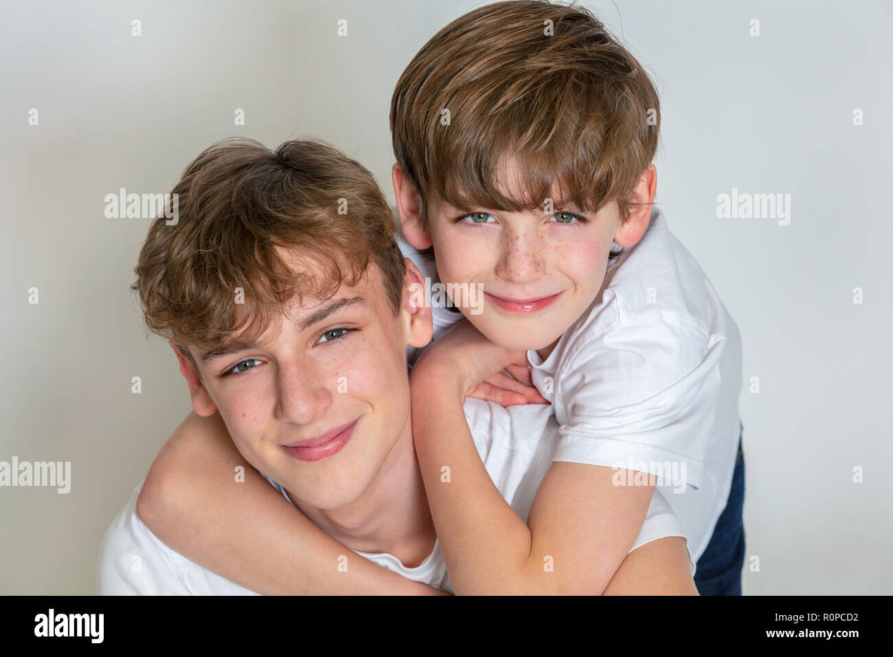 White background studio photograph of young happy boy children brothers smiling together Stock Photo