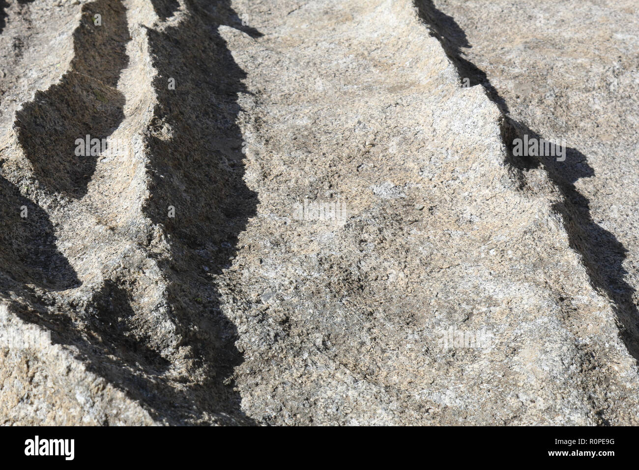 The sign of a dug surface due to water and ice erosion over a hard rock