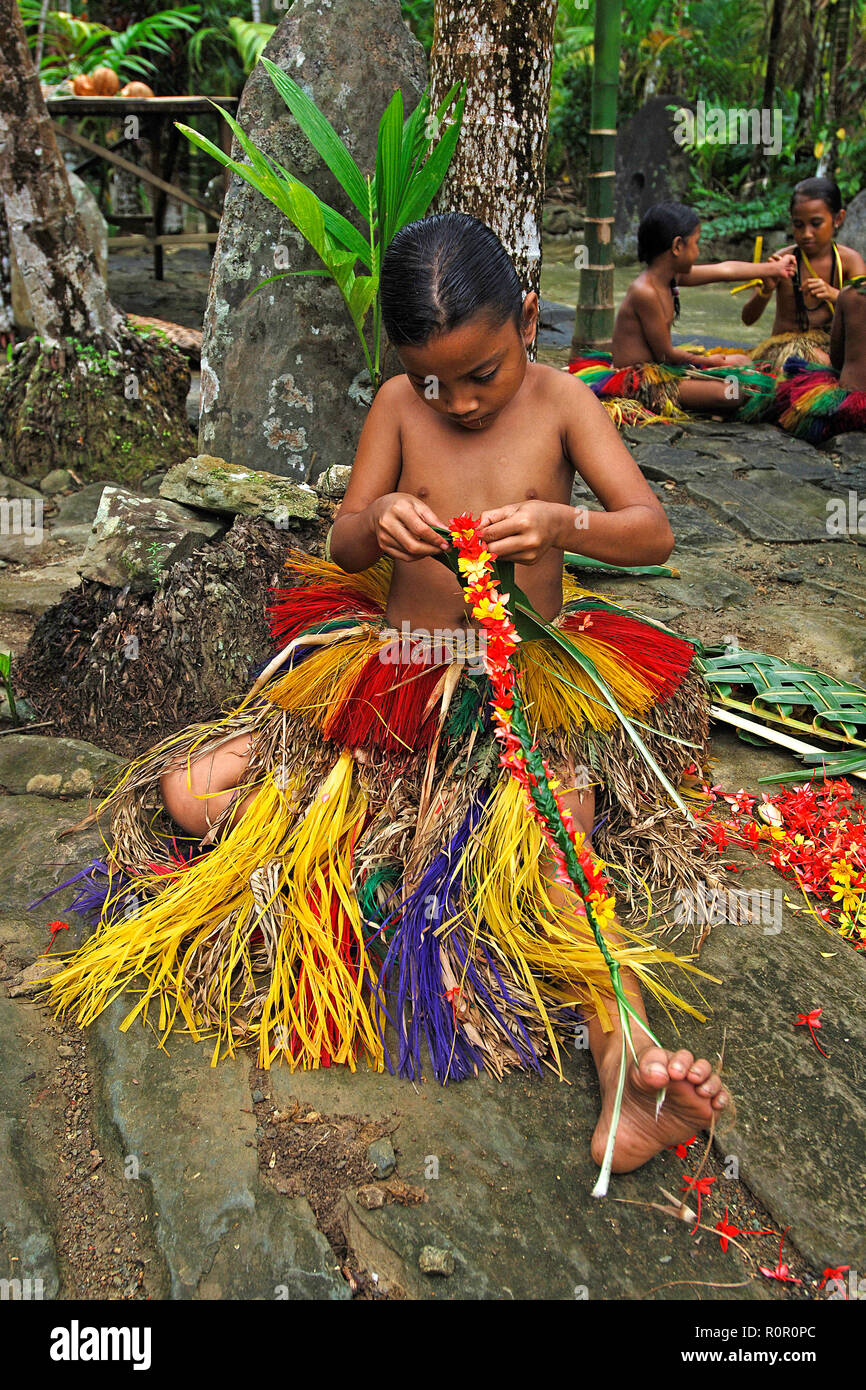 Local young girl preparing flower decorations for a traditional ceremony, Yap, Micronesia Stock Photo