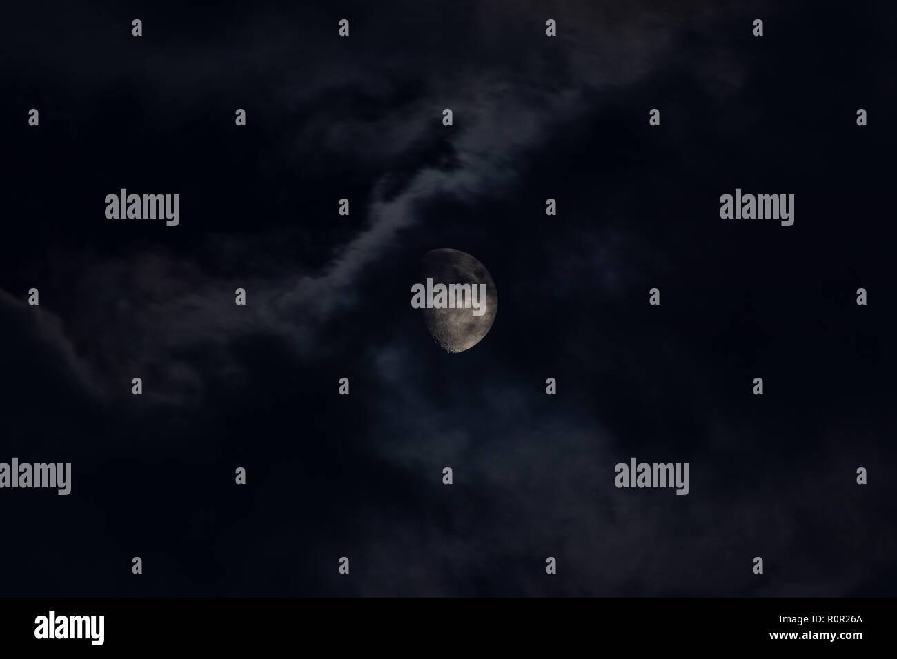 Moon behind clouds Stock Photo Alamy