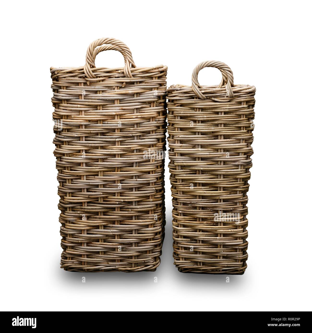 Two wicker baskets, with a white background, and a drop shadow. Stock Photo