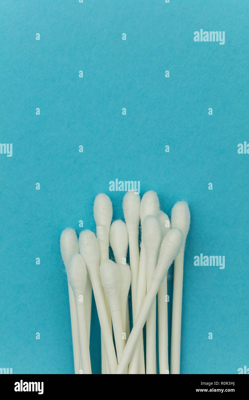 Cotton buds on a blue background. Sanitary qtip hygenic accessory. Plastic waste Stock Photo