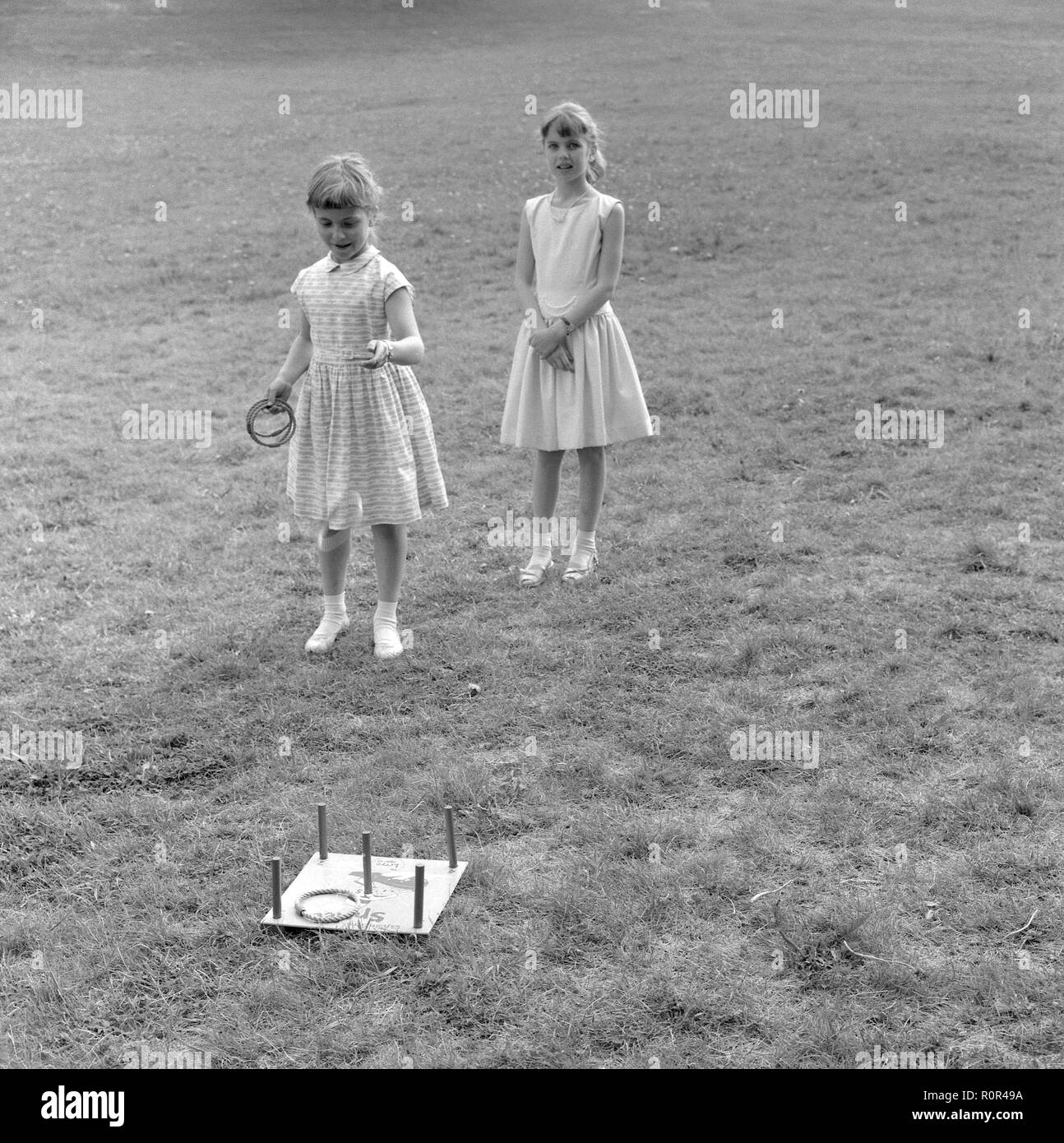 Summer activitiy in the 1950s. Two girls are playing a game of throwing rings. Hitting the middle ring gets the most points.  Sweden 1957 Ref 3480 Stock Photo