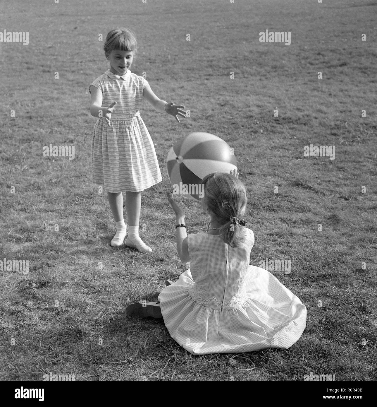 Summer activitiy in the 1950s. Two girls are playing with a ball on a summers dag 1957. Sweden Ref 3480 Stock Photo