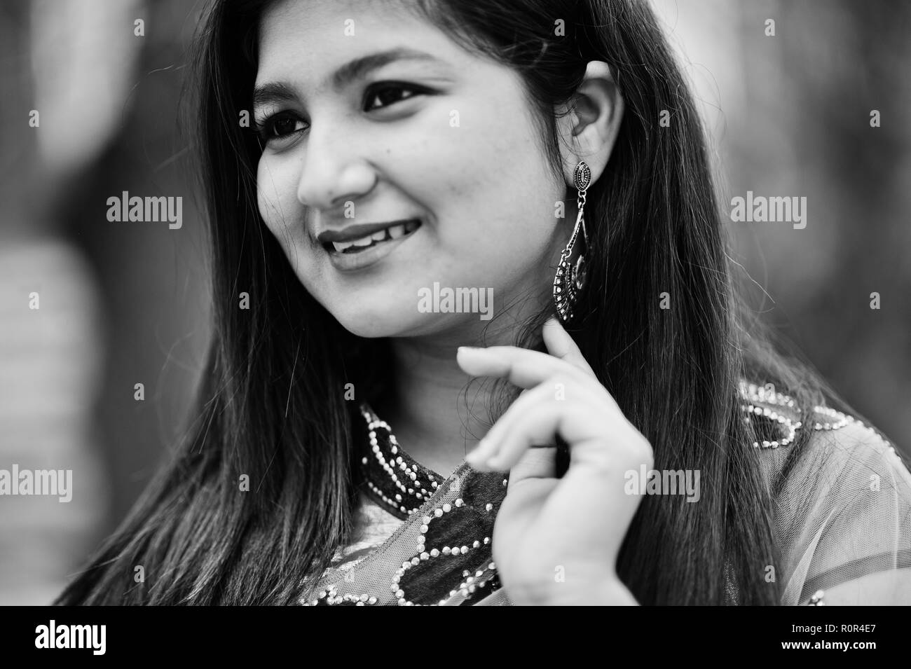 Close up portrait of indian hindu girl at traditional violet saree posed at street. Stock Photo