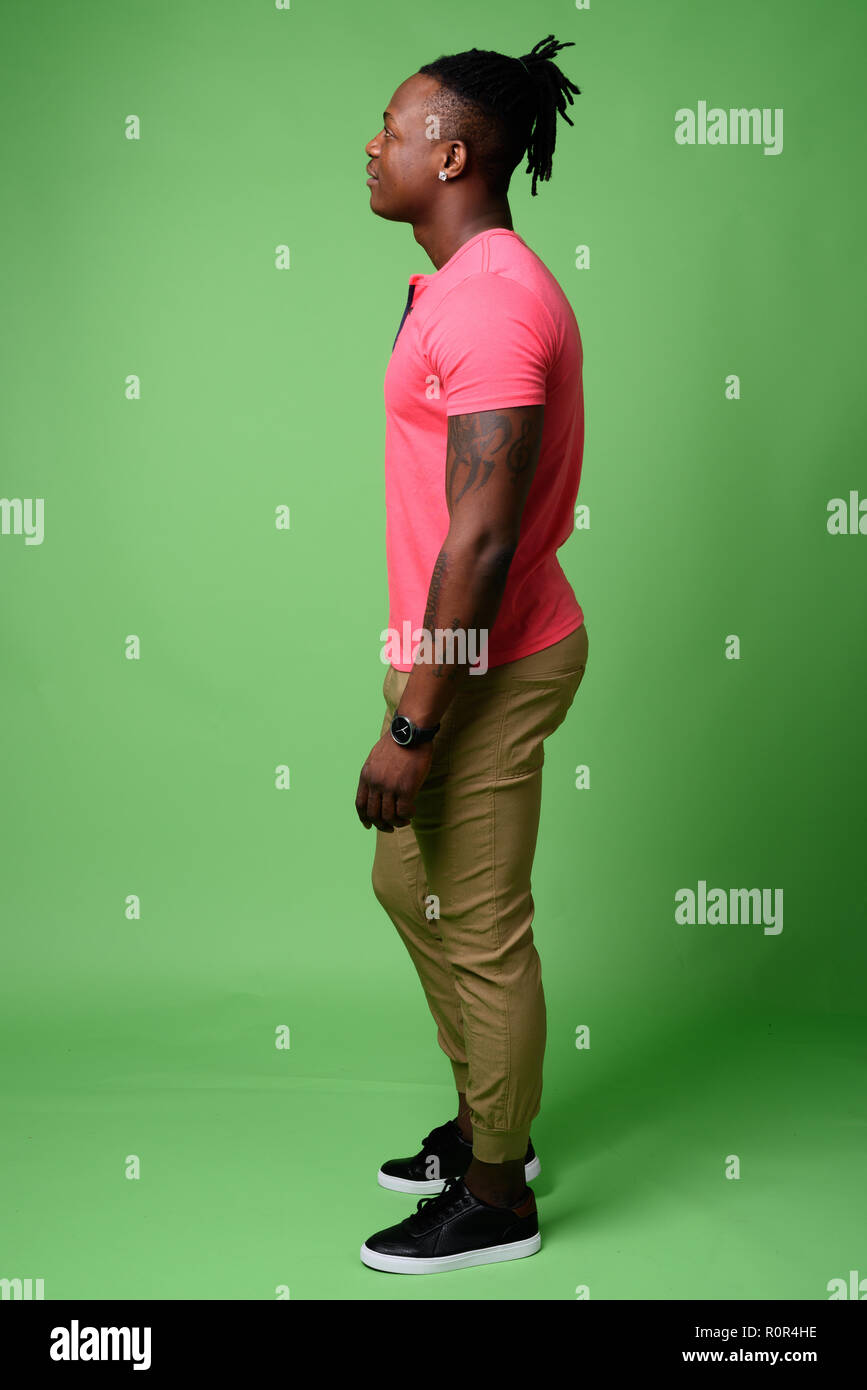 Young handsome African man from Kenya against green background Stock Photo