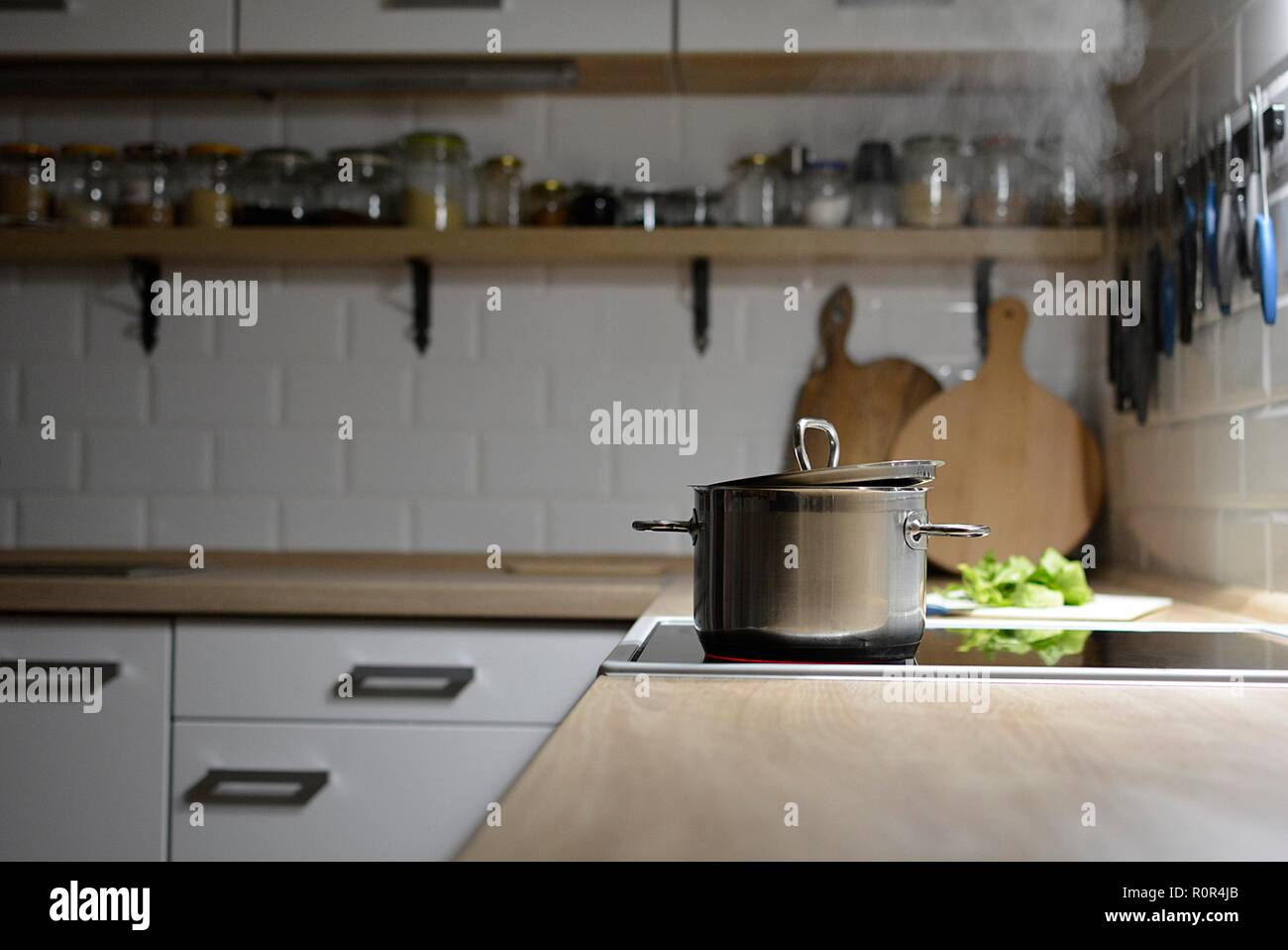 cooking dinner in a white modern kitchen Stock Photo