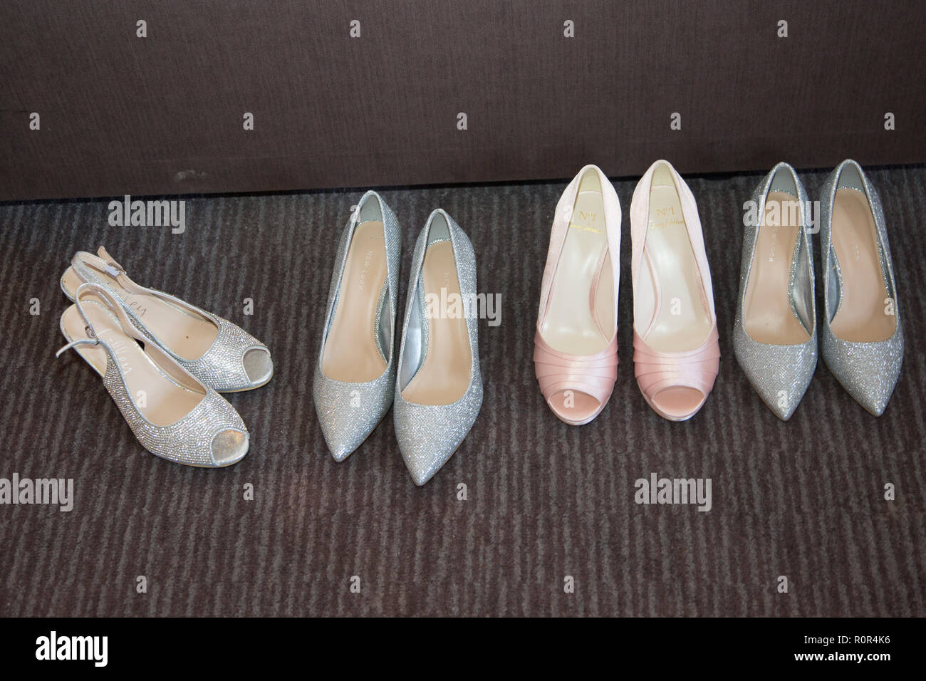 bride and bridesmaids shoes all lined up and ready to be worn on the wedding day Stock Photo