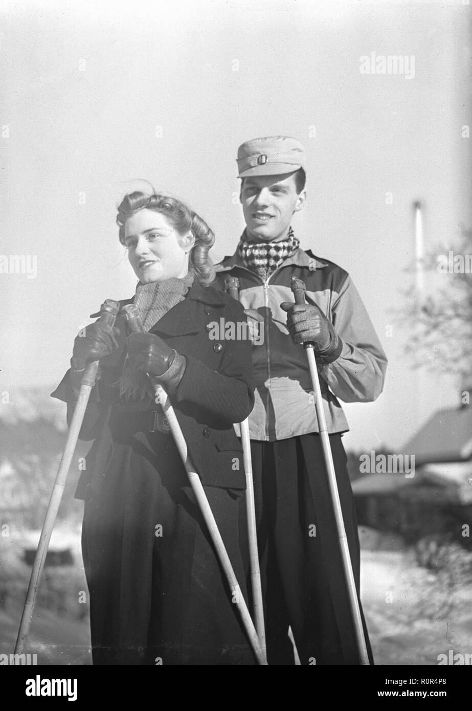 Winter in the 1940s. A young couple is enjoying their winter vacation and they are wearing