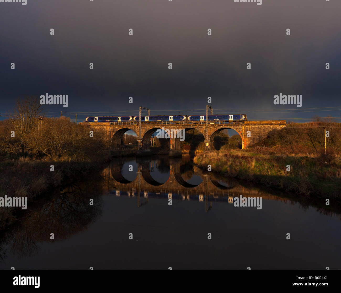 A Scotrail class 380 electric train crossing Garnock Longford viaduct