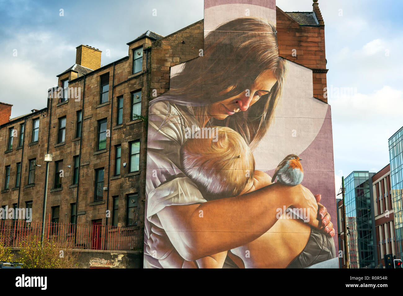 Mural of a mother and child painted on the gable and end of a traditional Glasgow tenement building at the junction of George Street and High Street,  Stock Photo