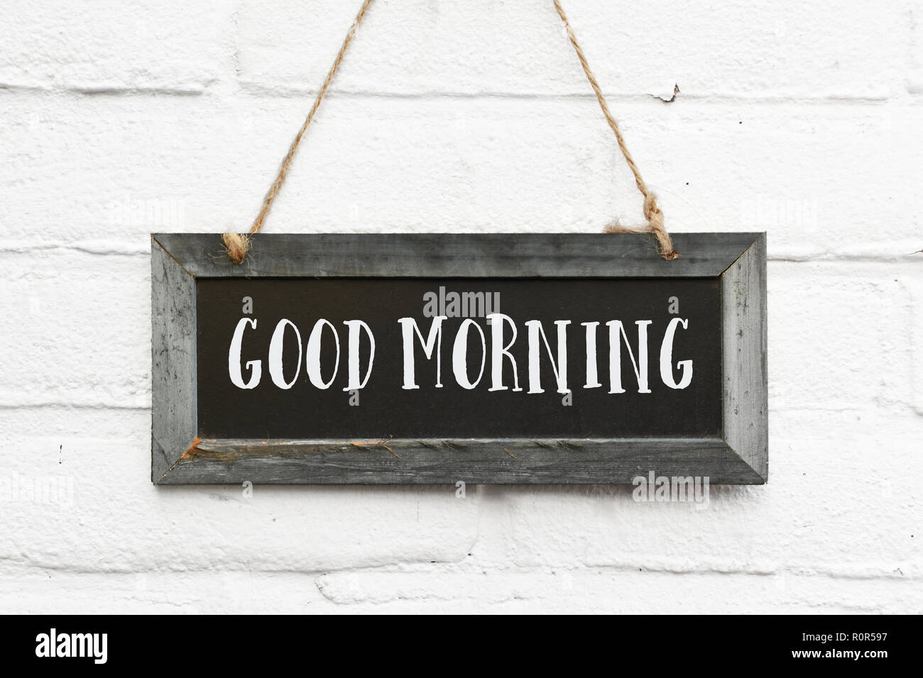 Hello good morning text on long hanging blackboard with wooden ...