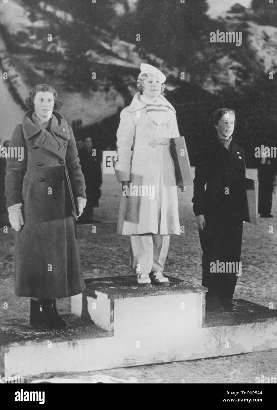 Olympic winter games 1936 Garmisch-Partenkirchen. The prize ceremony for womens figure skating with winner in the middle, Sonja Henie. Second is british Cecilia Colledge and third swedish Vivi-Anne Hultén. Stock Photo
