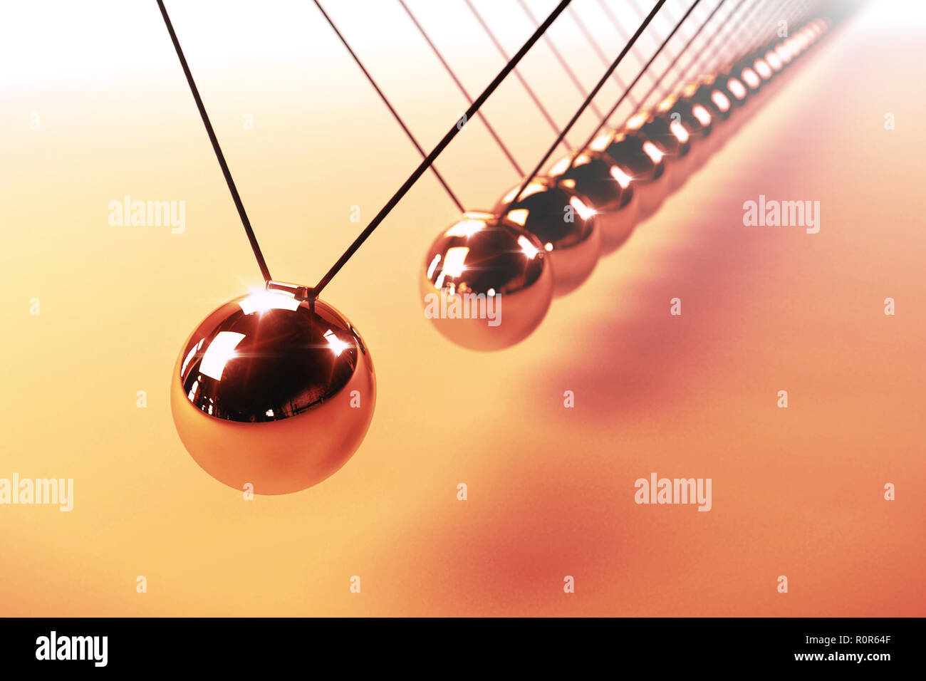 Newton's cradle, action and reaction concept, series of swinging spheres, device that demonstrates conservation of momentum and energy Stock Photo