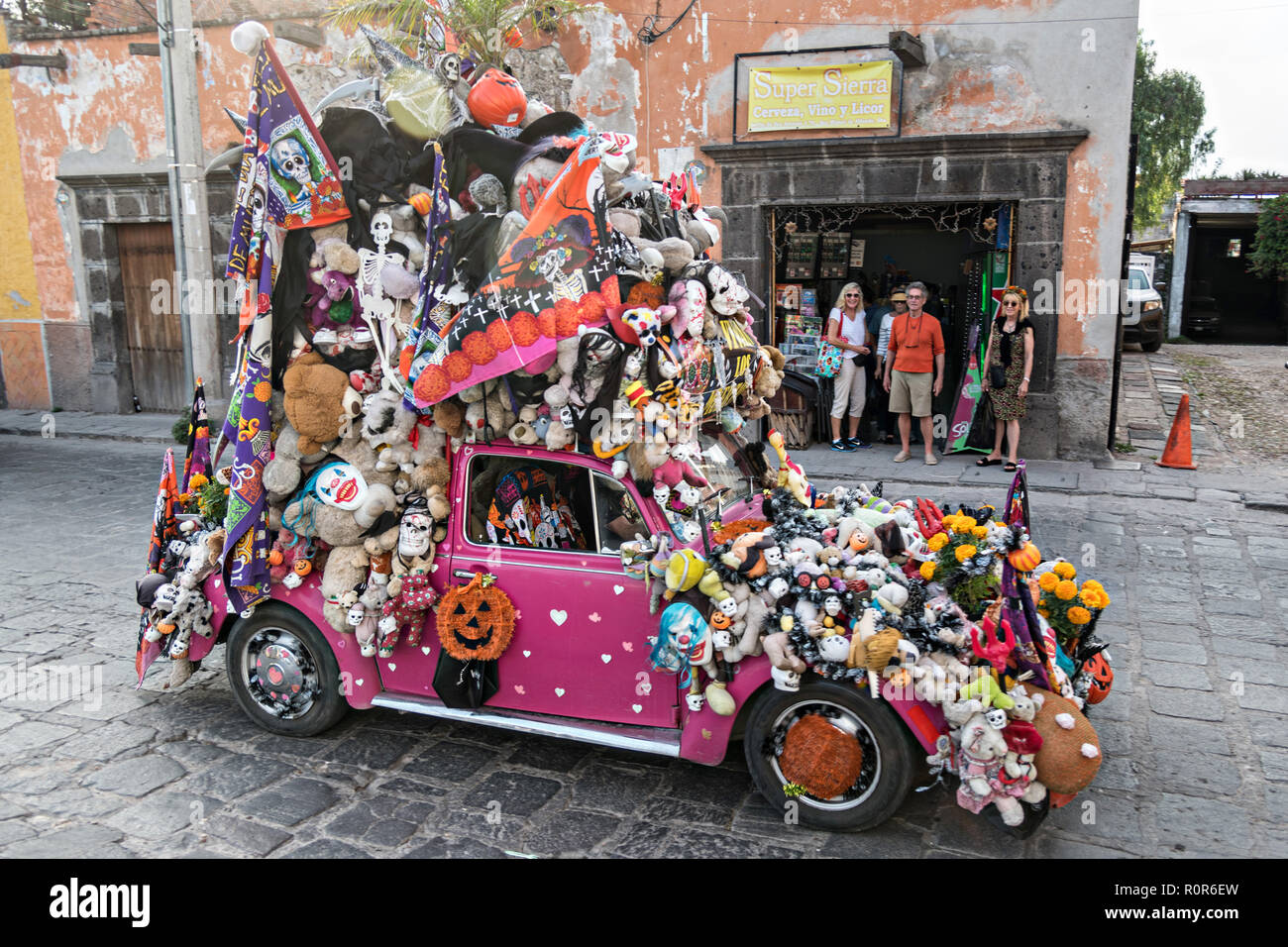 A Volkswagen Beetle art car decorated for Halloween and Dead of the Dead festivals drives down through the expat neighborhood of San Antonio in San Miguel de Allende, Mexico. Stock Photo