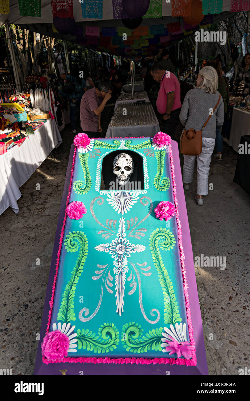A giant decorated coffin with a skeleton at the entrance to a holiday art market during Halloween and Dead of the Dead festivals in San Miguel de Allende, Mexico. Stock Photo