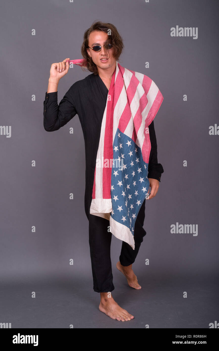 Portrait of young proud American man holding USA flag Stock Photo - Alamy
