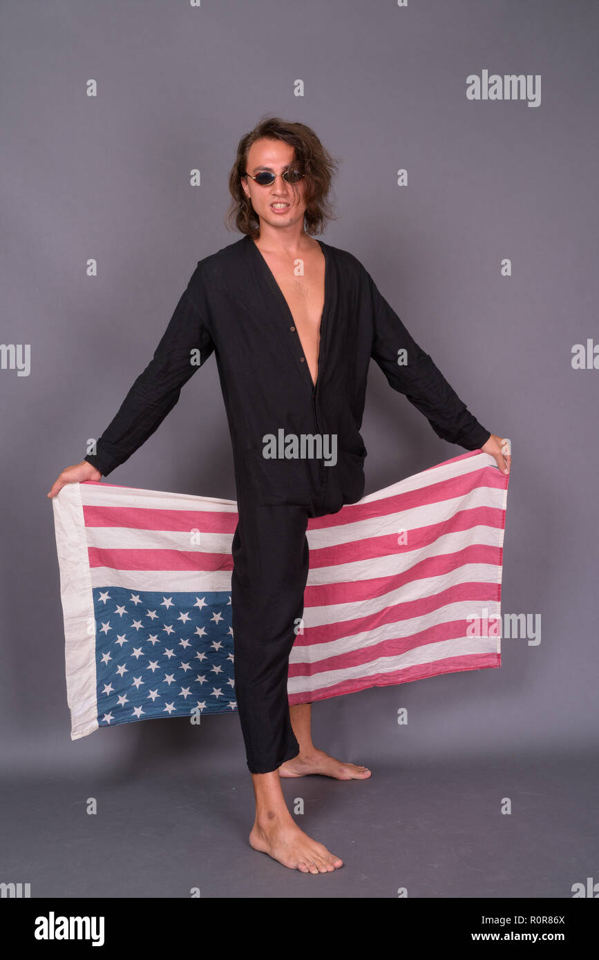 Portrait of young proud American man holding USA flag Stock Photo - Alamy