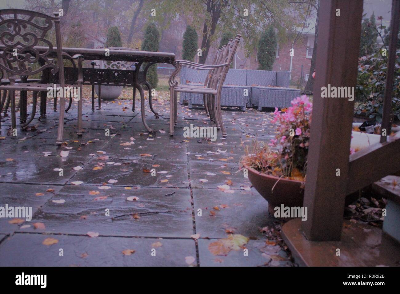 wet patio surface with outdoor furniture Stock Photo Alamy