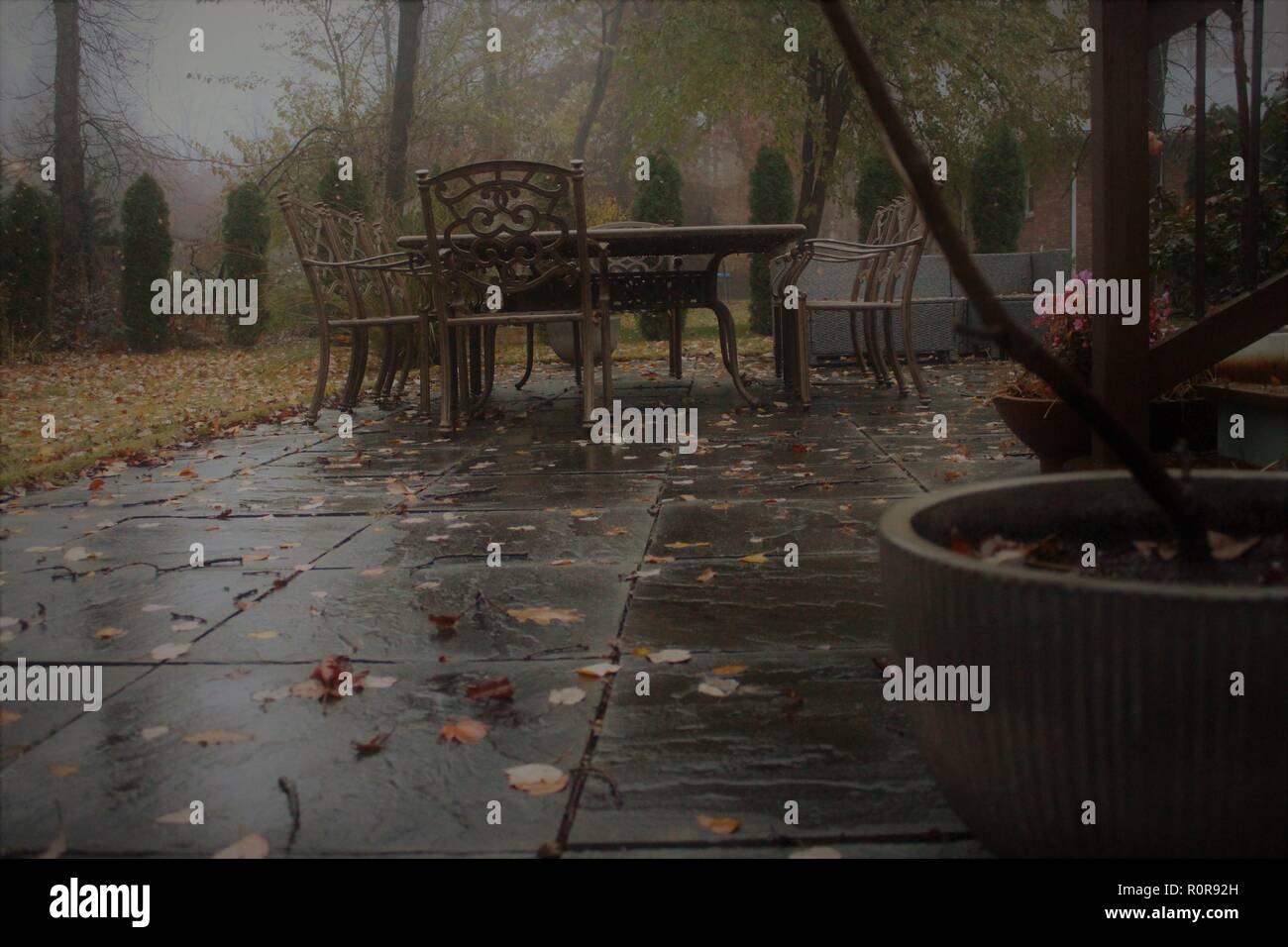 wet patio surface with outdoor furniture Stock Photo Alamy