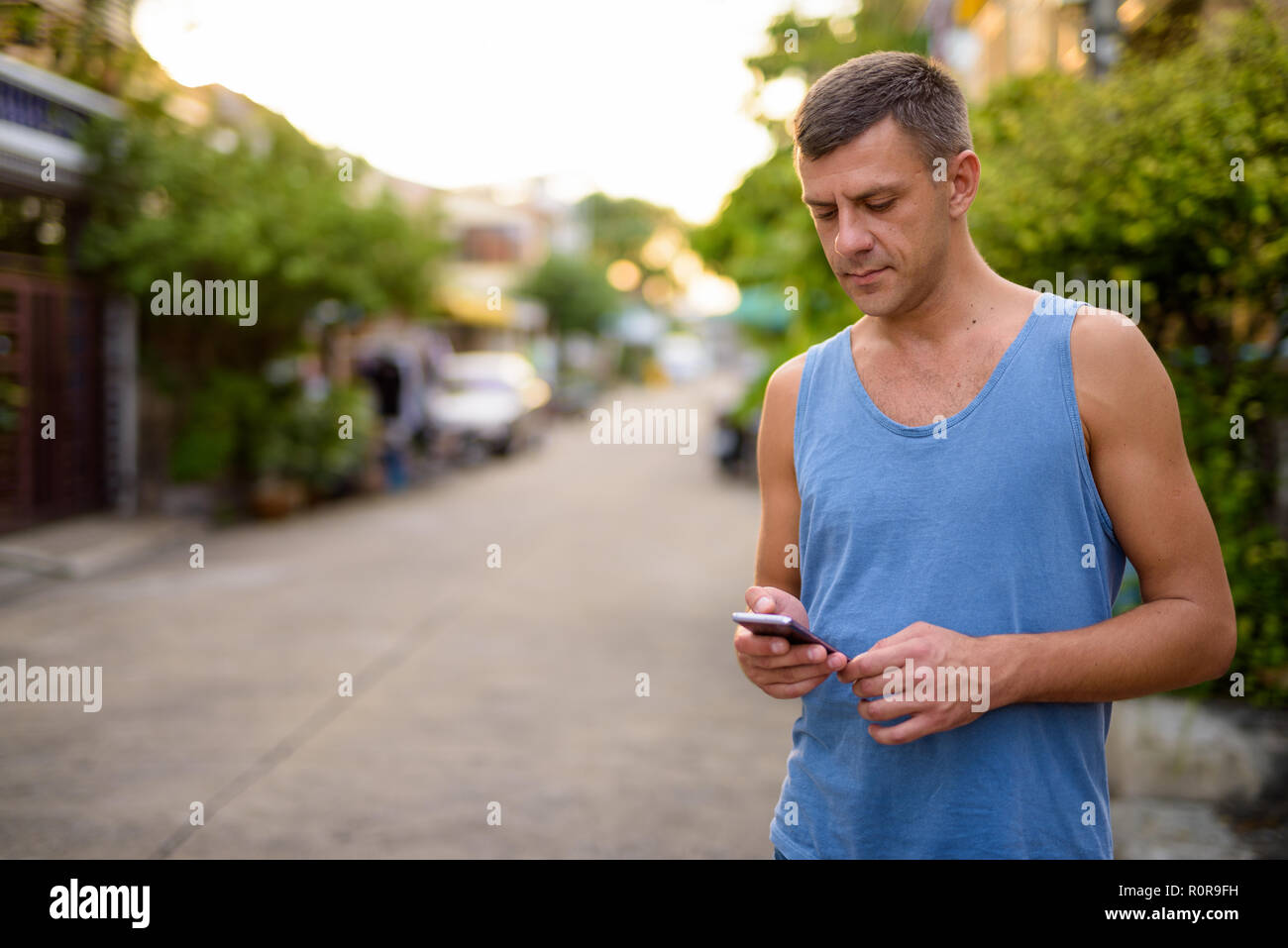 Handsome Man With Short Hair Relaxing In The Streets Outdoors
