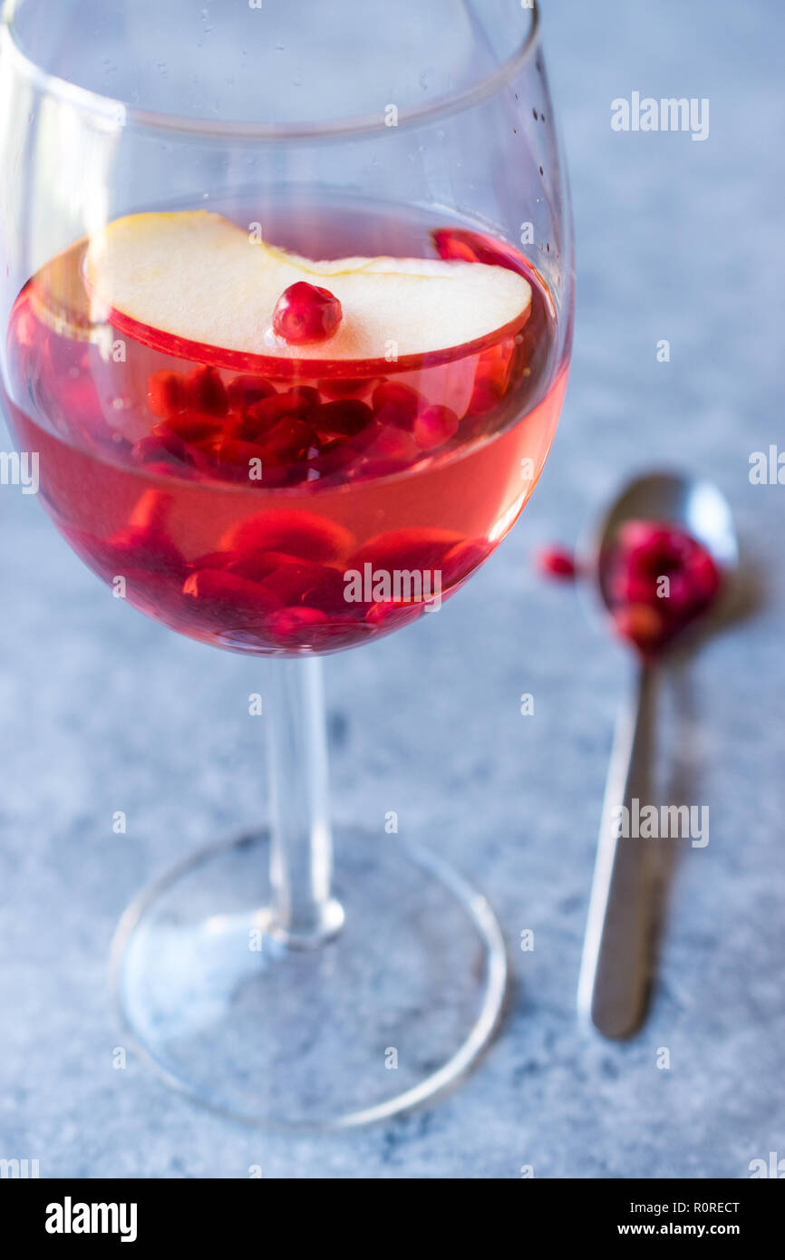 Rose Pink Blush Wine Cocktail with Pomegranate Seeds, Apple Slice and