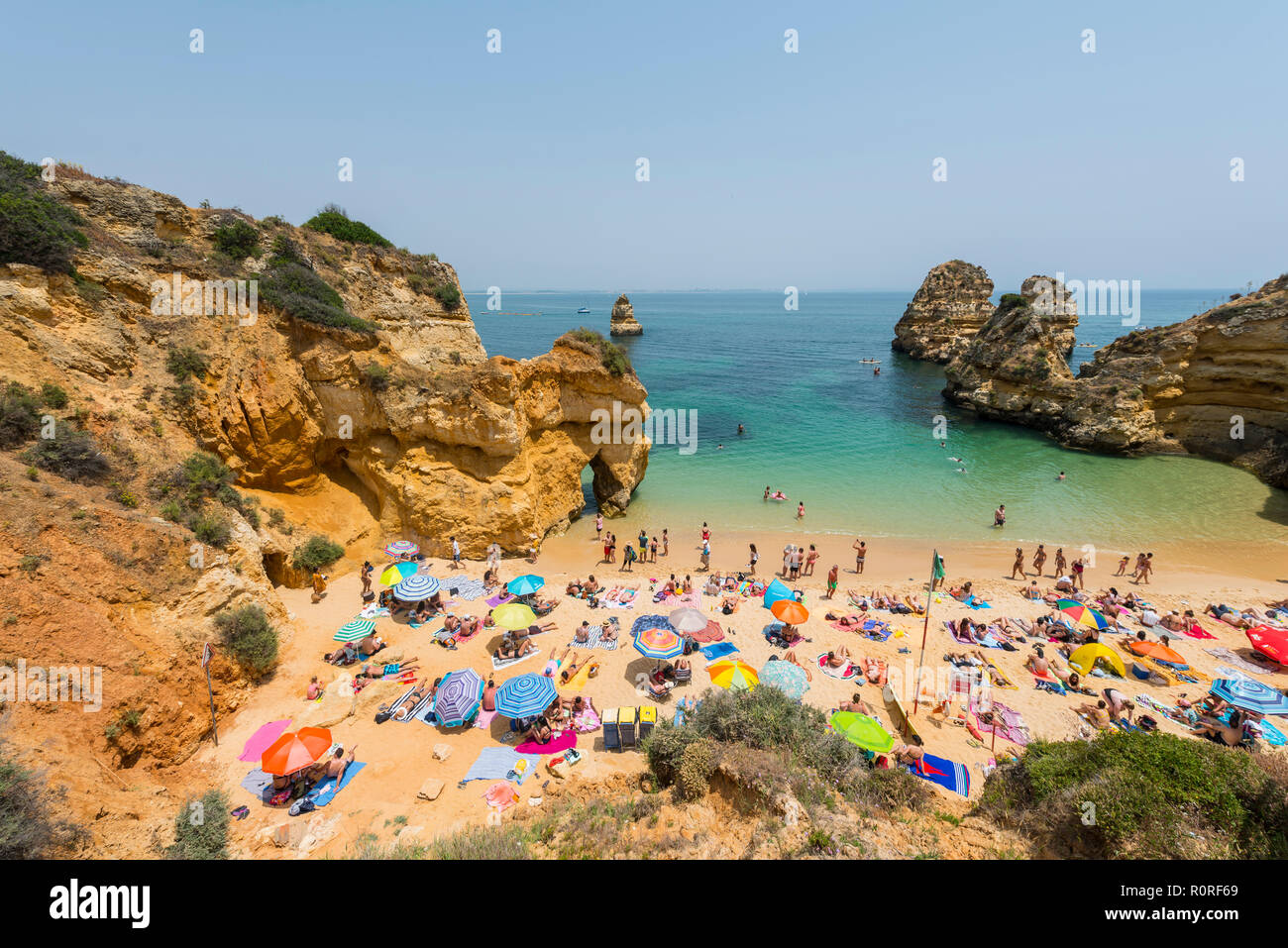 Tourists and bathers at the sandy beach, Praia do Camilo, Algarve rocky  coast, Lagos, Portugal Stock Photo - Alamy