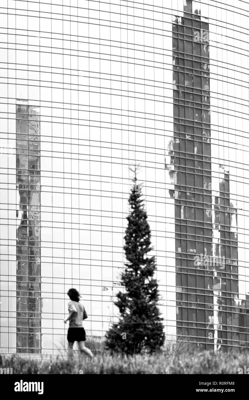 Running in the city park of Giardini di Porta Nuova, Milan - Italy Stock Photo