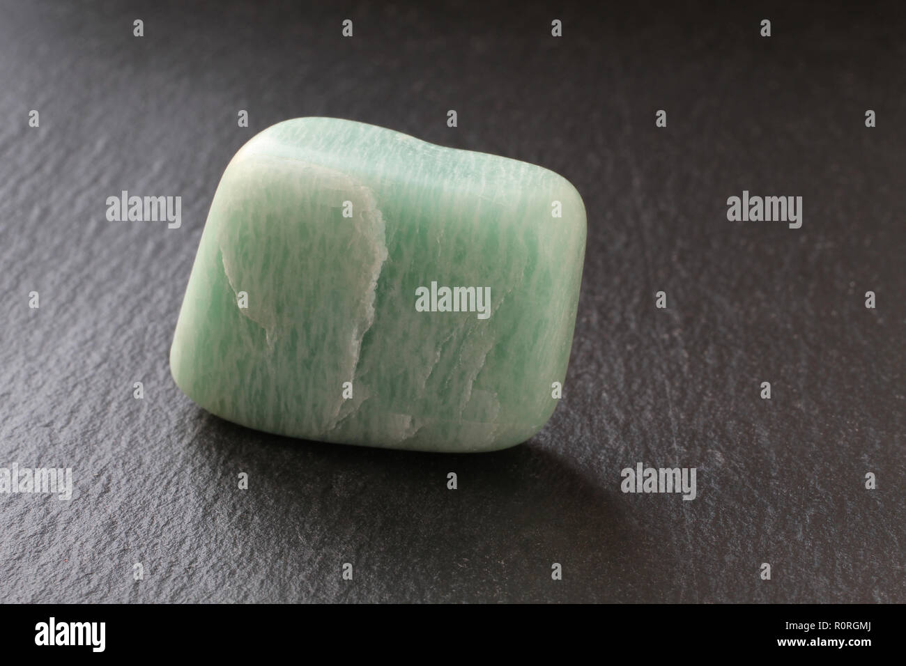 Aventurine stone on a black stone board Stock Photo