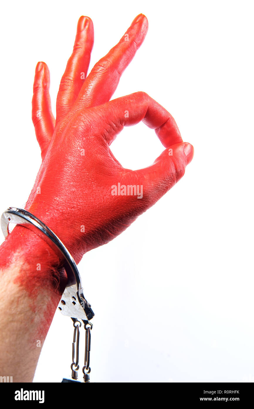 Caught red handed hand painted red wearing handcuffs concept Stock