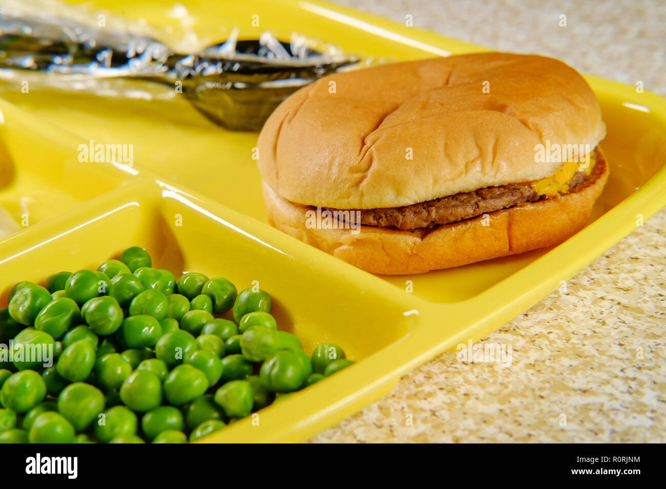 Elementary school lunch cheeseburger with mashed potatoes gelatin and