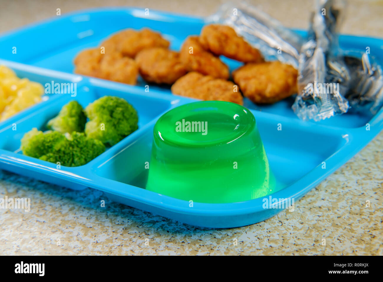 Grade school lunch tray of chicken nuggets with broccoli macncheese