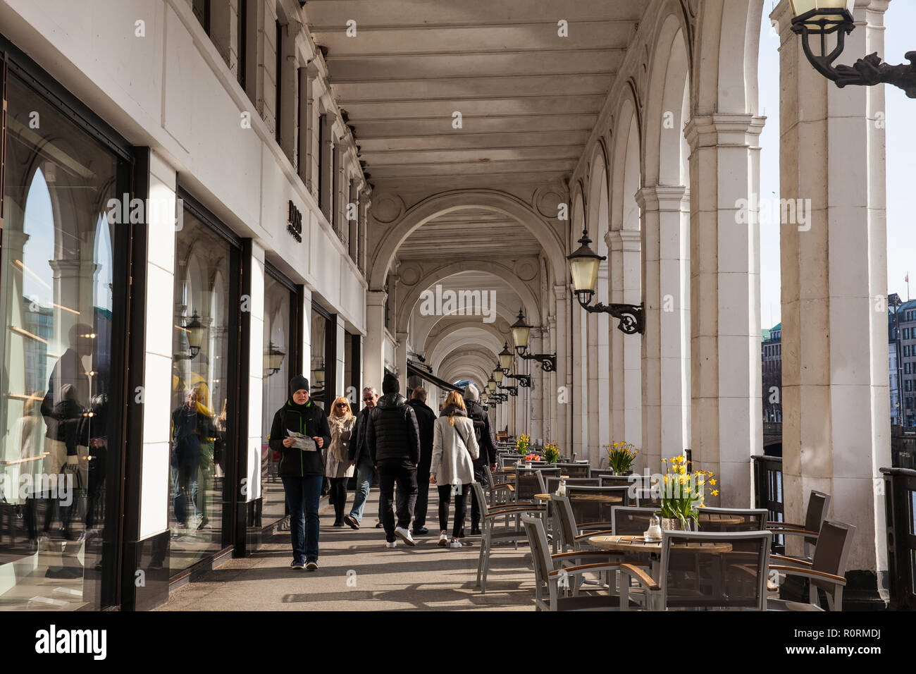 People walking at the beautiful commercial galery Alster Arkaden in a cold early spring Stock Photo