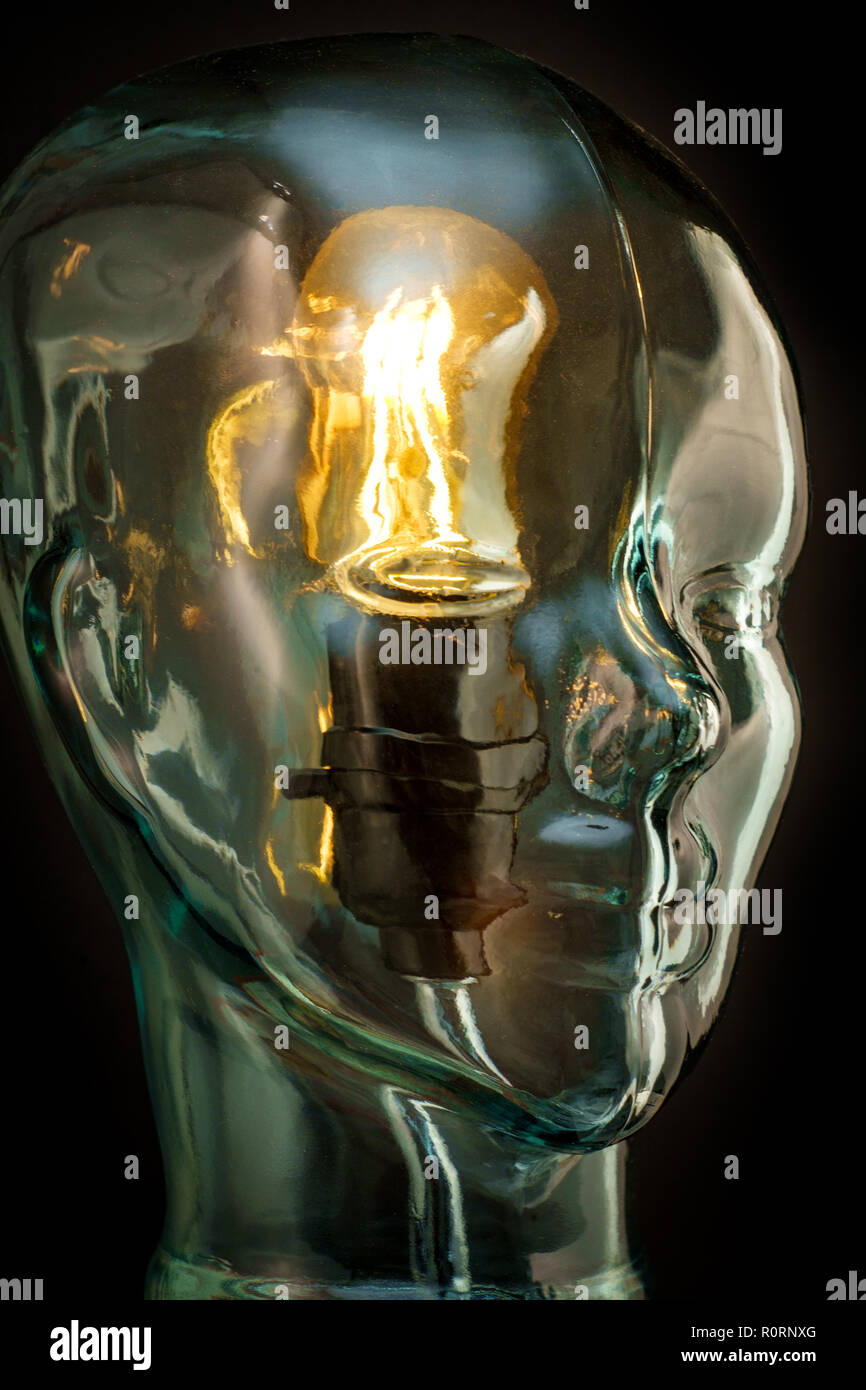 Bright lightbulb inside glass head for creative thoughts and ideas concept Stock Photo