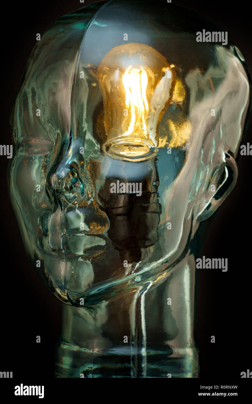 Bright lightbulb inside glass head for creative thoughts and ideas concept Stock Photo