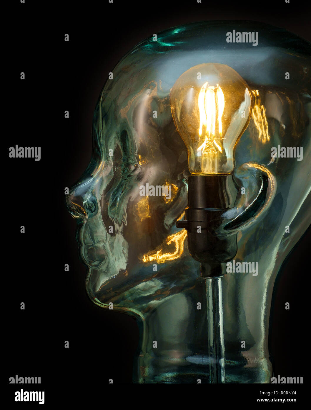 Bright lightbulb inside glass head for creative thoughts and ideas concept Stock Photo