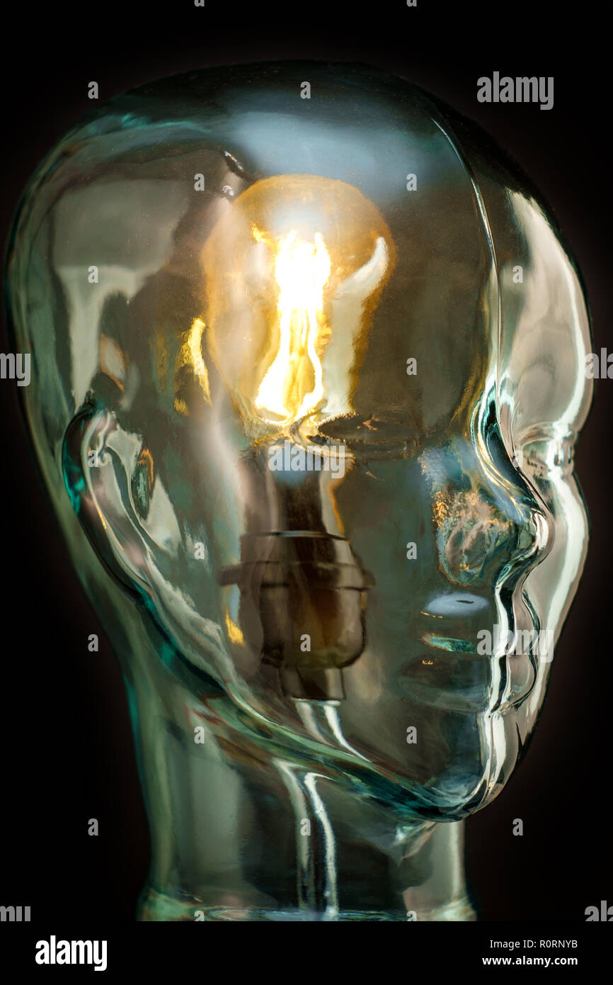 Bright lightbulb inside glass head for creative thoughts and ideas concept Stock Photo