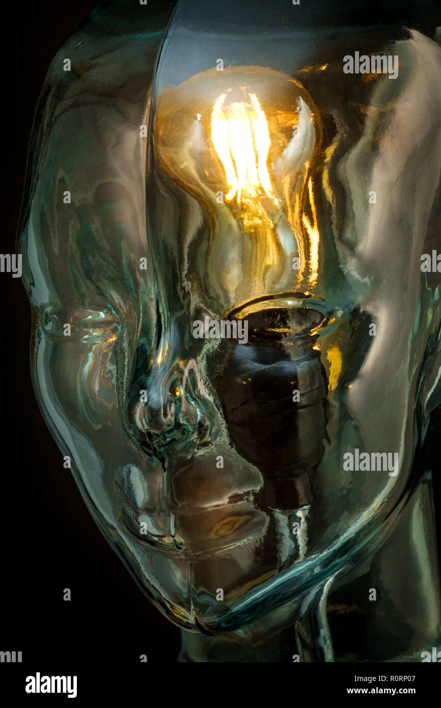 Bright lightbulb inside glass head for creative thoughts and ideas concept Stock Photo
